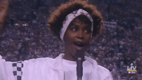 A Woman Singing Into A Microphone With The Words Liv Behind Her GIF