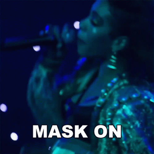 A Woman Singing Into A Microphone With The Words Mask On Written On The Bottom GIF