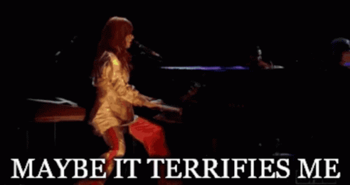 A Woman Singing Into A Microphone With The Words " Maybe It Terrifies Me " Below Her GIF