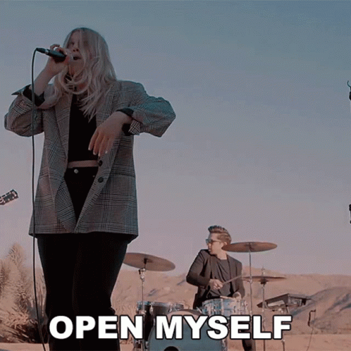 Woman Singing Into Microphone With Open Myself Text GIF