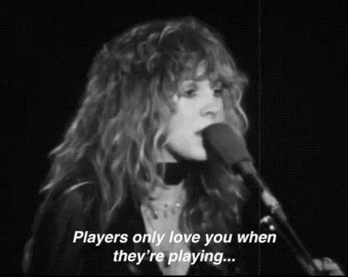 A Woman Singing Into A Microphone With The Words `` Players Only Love You When They 'Re Playing ... '' GIF