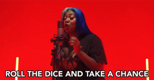 A Woman Singing Into A Microphone With The Words " Roll The Dice And Take A Chance " Below Her GIF