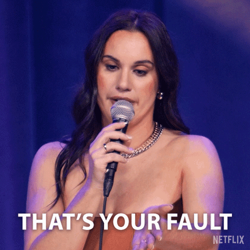 A Woman Singing Into A Microphone With The Words That 'S Your Fault On The Bottom Right GIF