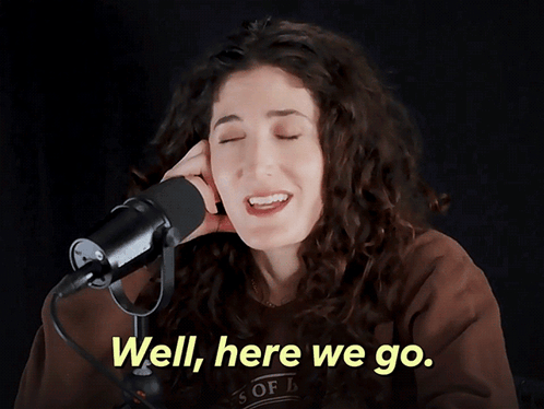 A Woman Singing Into A Microphone With The Words " Well Here We Go " Above Her GIF