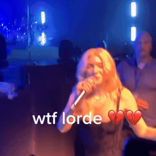 A Woman Singing Into A Microphone With Wtf Lorde Written On The Bottom GIF