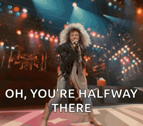 A Woman Singing On Stage With The Words Oh You 'Re Halfway There GIF