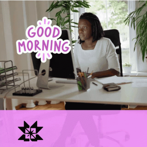 A Woman Sits At A Desk In Front Of A Computer With The Words Good Morning Written On It GIF