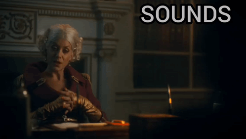 A Woman Sits At A Desk With The Words " Sounds Ridiculous But Go On " Below Her GIF