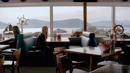 Woman Sitting At Waterfront Restaurant GIF