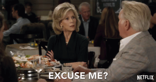 A Woman Sits At A Table With A Man And Says " Excuse Me " In Front Of Her GIF