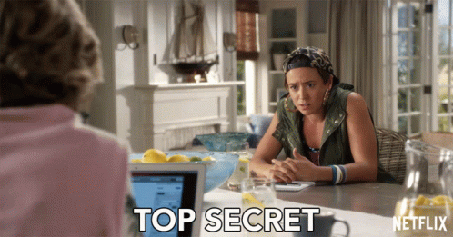 A Woman Sits At A Table With A Netflix Logo On The Bottom GIF