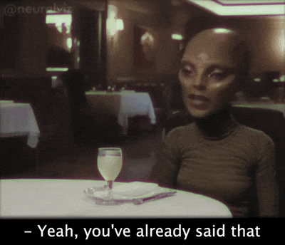 A Woman Sits At A Table With A Wine Glass And Says Yeah You 'Ve Already Said That GIF