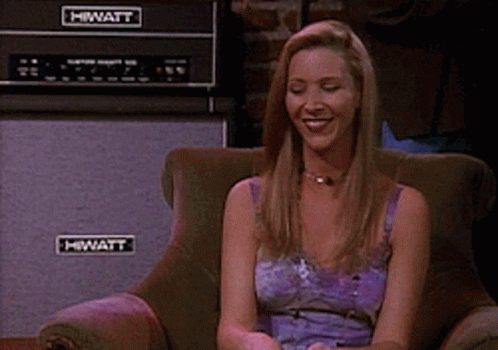 A Woman Sits In A Chair With A Hiwatt Amplifier In The Background GIF