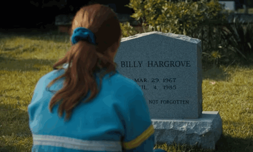 A Woman Sits In Front Of A Gravestone That Says Billy Hargrove GIF