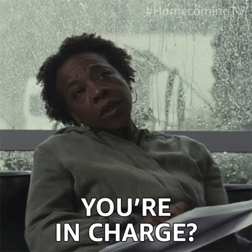 a woman sits in front of a window and says you 're in charge