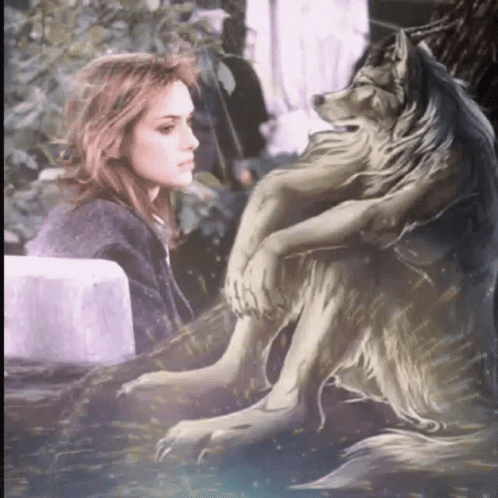 A Woman Sits Next To A Statue Of A Wolf With A Long Mane GIF