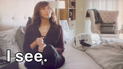 A Woman Sits On A Bed With The Words " I See " Written Below Her GIF