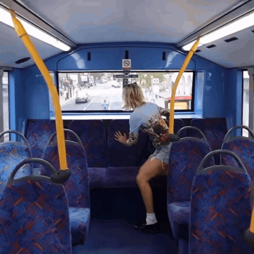 A Woman Sits On A Bus With A Sign That Says No Smoking GIF
