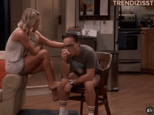 A Woman Sits On A Couch While A Man Sits In A Chair With The Words Trendizisst Written On The Bottom GIF