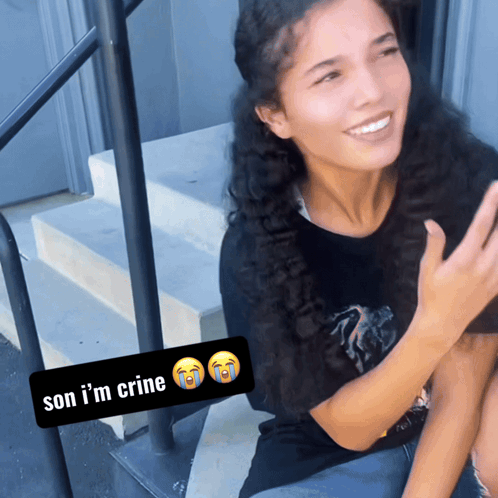 A Woman Sits On A Set Of Stairs With A Sticker Saying Son I 'M Crine GIF