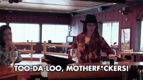 A Woman Sitting At A Bar With The Words Too-Da-Loo Motherfuckers GIF