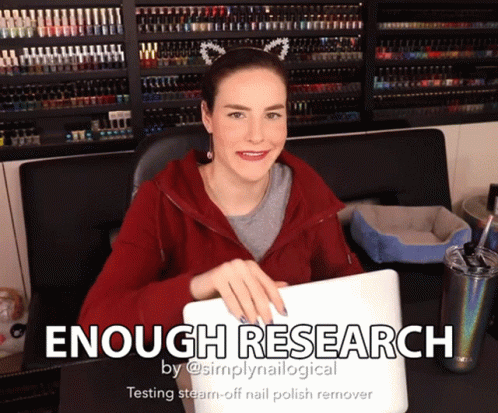 A Woman Sitting At A Desk With A Laptop And The Words " Enough Research " On The Bottom GIF