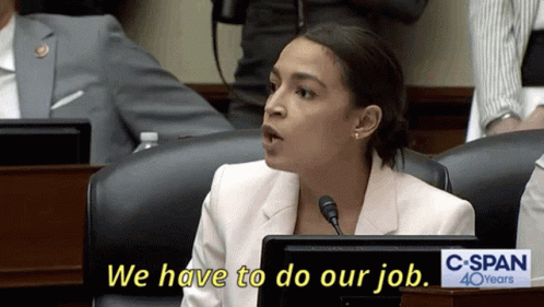 A Woman Sitting At A Desk With A Sign That Says C Span 40 Years GIF