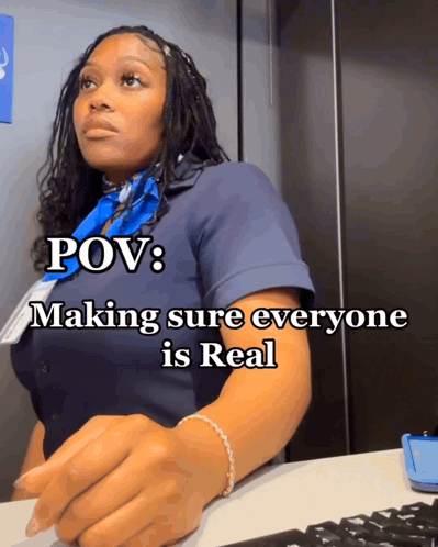 A Woman Sitting At A Desk With The Words Pov Making Sure Everyone Is Real On The Bottom GIF