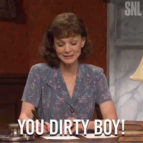 A Woman Sitting At A Desk With The Words " You Dirty Boy " Written On Her Face GIF