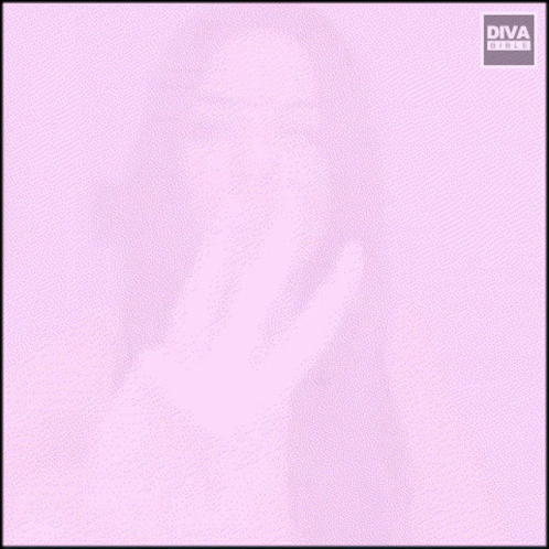 A Woman Sitting At A Table Making A Peace Sign GIF