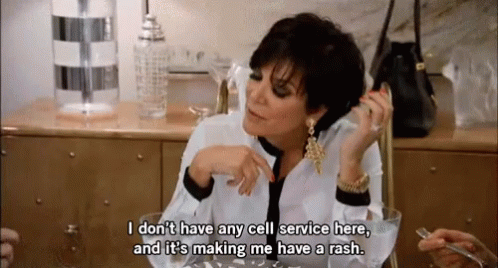A Woman Sitting At A Table Talking On A Cell Phone And Saying " I Don T Have Any Cell Service Here " GIF