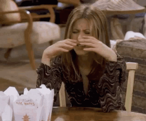 A Woman Sitting At A Table With A Box Of Thank You Chinese Food GIF
