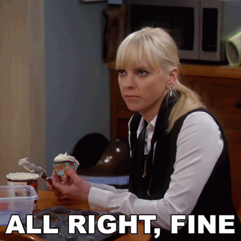 A Woman Sitting At A Table With A Cupcake And The Words All Right Fine GIF