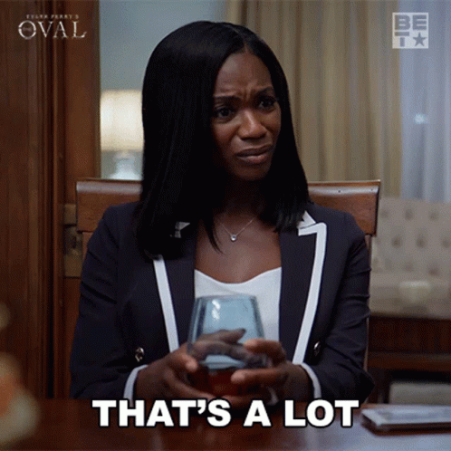A Woman Sitting At A Table With A Glass Of Wine And The Words That 'S A Lot GIF