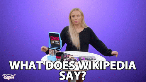 A Woman Sitting At A Table With A Pop Buzz Mirror GIF