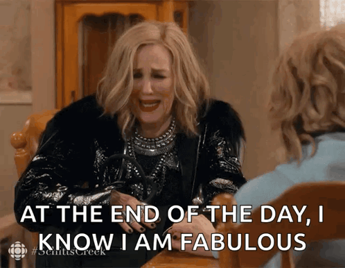 A Woman Sitting At A Table With The Words At The End Of The Day I Know I Am Fabulous In Front Of Her GIF