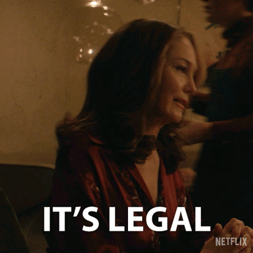 A Woman Sitting At A Table With The Words It 'S Legal On The Bottom GIF