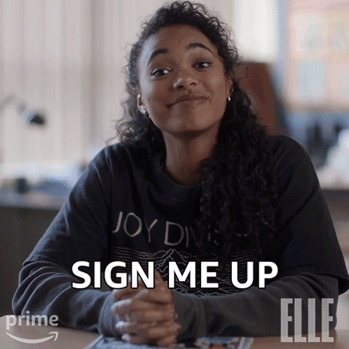A Woman Sitting At A Table With The Words Sign Me Up Written On Her Face GIF