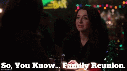 A Woman Sitting At A Table With The Words " So You Know Family Reunion " Above Her GIF