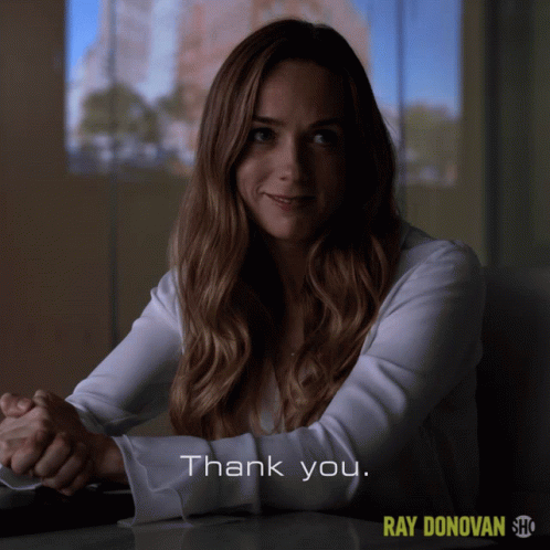 A Woman Sitting At A Table With The Words Thank You On The Bottom Right GIF