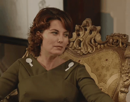 A Woman Sitting In A Chair With Her Eyes Closed GIF