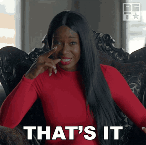 A Woman Sitting In A Chair With Her Finger On Her Nose And The Words That 'S It GIF