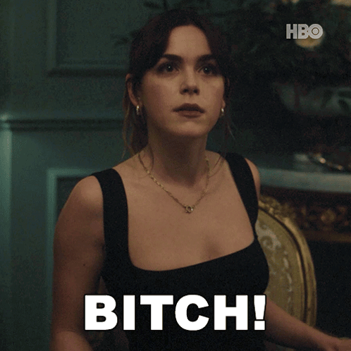A Woman Sitting In A Chair With The Word Bitch Written On Her Chest GIF