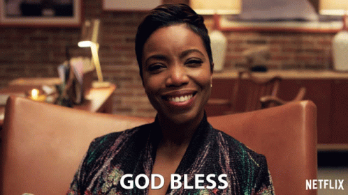 A Woman Sitting In A Chair With The Words God Bless Written On The Bottom GIF