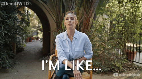 A Woman Sitting In A Chair With The Words I 'M Like Written Below Her GIF