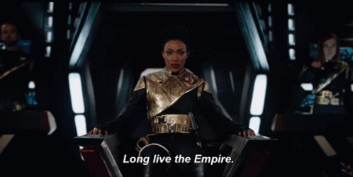 A Woman Sitting In A Chair With The Words Long Live The Empire On The Bottom GIF
