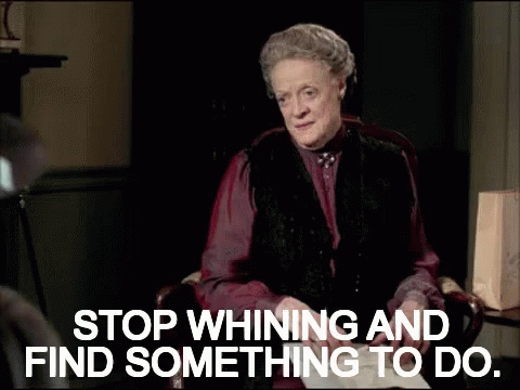 A Woman Sitting In A Chair With The Words " Stop Whining And Find Something To Do " GIF