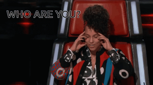 A Woman Sitting In A Chair With The Words " Who Are You " Written Above Her GIF