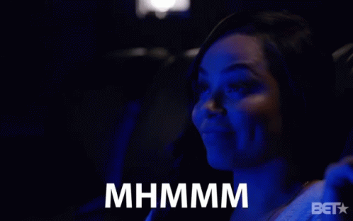 A Woman Sitting In A Dark Room With A Bet Logo On The Bottom Right GIF