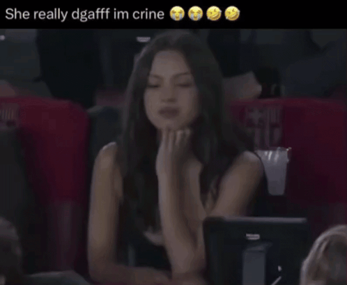 A Woman Sitting In A Stadium With The Words She Really Dgafff Im Crine GIF